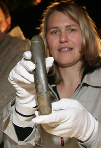 Jedna z archeoložek pózuje s prehistorickým dildem nalezeným v Německu